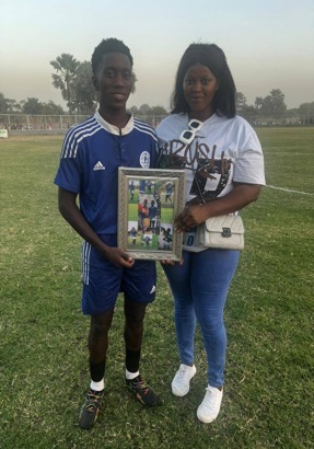 Avid football enthusiast Aminata Janneh embellishes winger Dawda Sowe with certificate