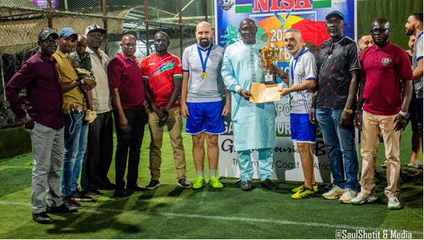 E-Mad Football Academy clasp NISA Six-A-Side Tournament trophy