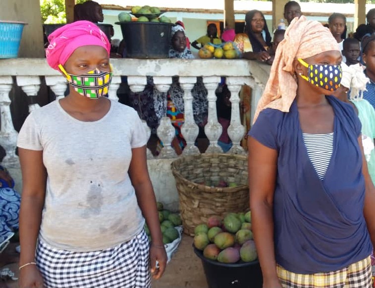 The Rural Child gives face masks to vendors, children and Police