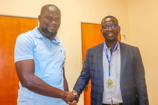 GFAA chair Yahya Manneh decorates GFF SG Lamin M. Jassey with medal