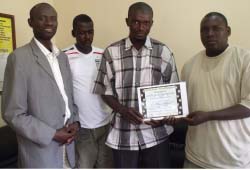 Kunting Youth and Sports Development Committee, two others receive materials from FG