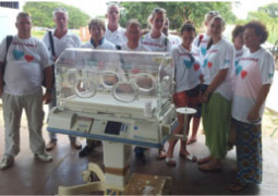 donated incubator with philanthropists standing at the back