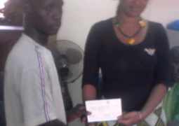 modou bojang kksdc chairman receiving cheque from gamcel nancy