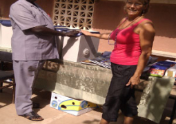 mr sonko receiving the donated items from dinemarie