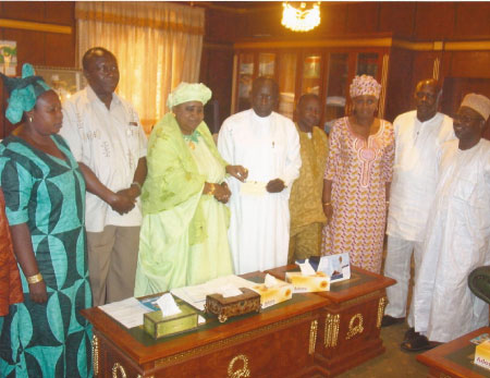 Timber re-exporters present cheque to VP