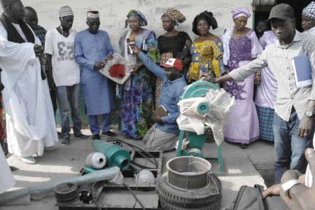 North Bank people smile as minister presents equipment